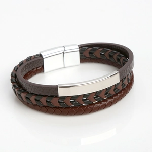 Detail of brown multilayer leather bracelet with silver magnetic clasp on white background