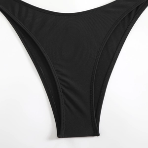 Detail of black high-cut bikini bottoms showing elastic fabric and reinforced stitching