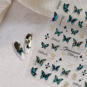 Elegant steampunk butterfly nail art stickers with gold foil gears and blue motifs