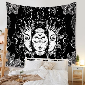 Detail of bohemian sun and moon tapestry hanging above bed in a cozy bedroom