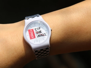 Detail shot of a white silicone watch featuring a trendy black and white checkered strap