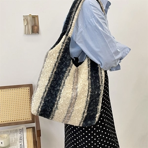 Detail of black and white striped fleece tote bag showing plush texture and spacious design