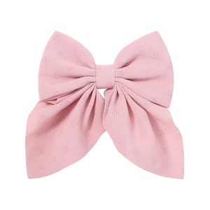 Elegant large pink floral bow hair clip with textured fabric and long ribbon streamers