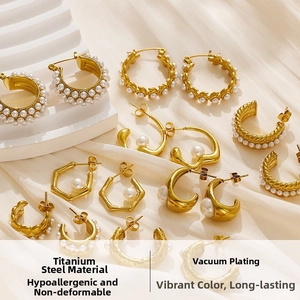 Detail view of vintage gold hoop earrings made of titanium steel with faux pearls