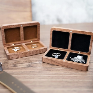 Macro detail of walnut wood jewelry box featuring dual compartments and plush velvet lining