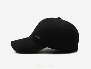 Side view of winter baseball cap with ear protection and silver fashion metal label