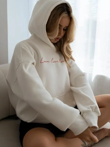 Oversized white hoodie with red Love print and drawstring hood for a cozy autumn look