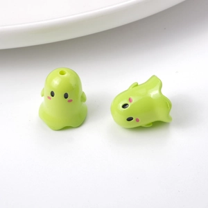 Close-up of green cartoon ghost resin beads for DIY jewelry and phone chain making