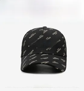 Close-up of black baseball cap featuring gold 'FASHION' embroidery and woven pattern