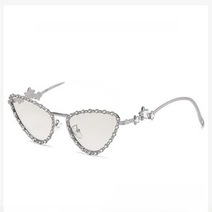 Detail of silver cat-eye sunglasses featuring beaded edges and metal star accents