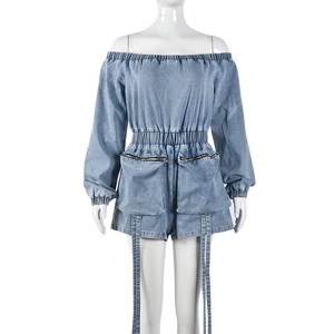 Detail view of washed blue denim romper with elastic waist and large cargo zip pockets