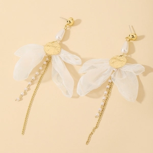 Detail of bohemian pearl drop earrings with gold metal discs and white fabric petals