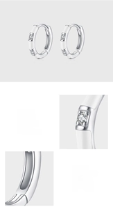 Macro detail of S925 sterling silver hoop earrings with white enamel and 5A zircon