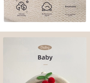 Detail of baby knit beret showing breathable fabric, cherry ornament and soft texture