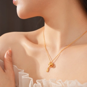 Detail of gold rocking horse pendant and tag on a minimalist layering necklace for women