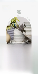 Detail of cream ceramic tableware with wavy edges and handcrafted hammered texture