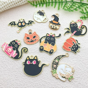 Flat lay of colorful Halloween alloy charms featuring black cat and pumpkin for DIY jewelry