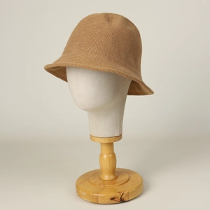 Detailed close-up of khaki knitted bucket hat with a breathable texture and minimalist design