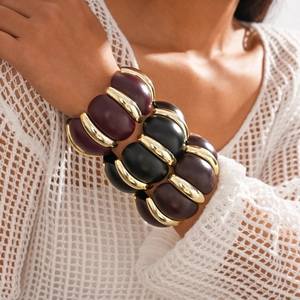 Acrylic geometric chunky bracelets with deep purple and black segments and gold accents