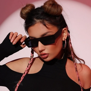 Fashionable black rectangle sunglasses for women styled with a pink woven headband