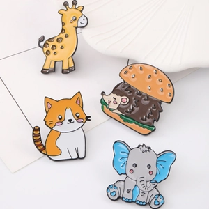 Cute cartoon enamel pin set featuring a giraffe, cat, hedgehog burger, and blue-eared elephant