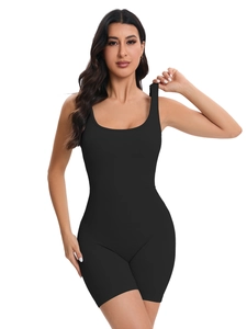 Seamless black ribbed yoga bodysuit with U-neck straps and slim fit peach lift shorts