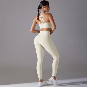 Back view of cream yoga set showing cross-back sports bra and high-waist lifting leggings