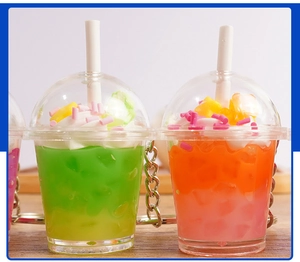 Close-up of cute miniature drink keychains with cream topping and colorful sprinkles