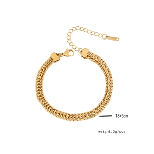 Detail of gold stainless steel woven chain bracelet with lobster clasp and extension