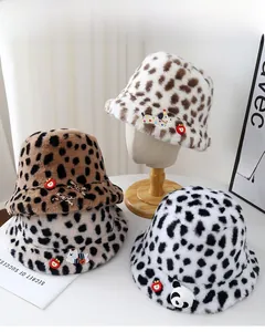 Detailed view of plush leopard print bucket hats with cute cartoon patches for winter fashion