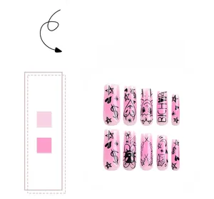 Detail of pink gradient press-on nails with black graffiti stars and heart patterns
