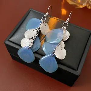 Blue petal tassel earrings with frosted silver discs for a stylish seaside vacation look