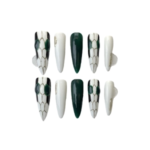 Handmade stiletto press-on nails featuring dark green snakeskin patterns and silver accents