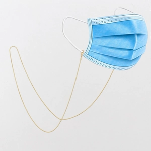 Exquisite gold metal chain for glasses and face masks with secure clasps on white backdrop