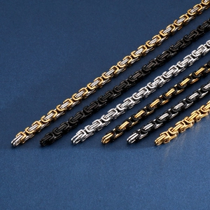 Macro shot of assorted titanium steel flat curb chains in mixed metallic finishes