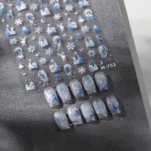 Detail view of M-753 winter nail stickers with blue reindeer and snowflake motifs