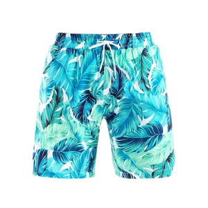 Détail du short de bain pour hommes à séchage rapide avec imprimé palmier bleu et cordon blanc