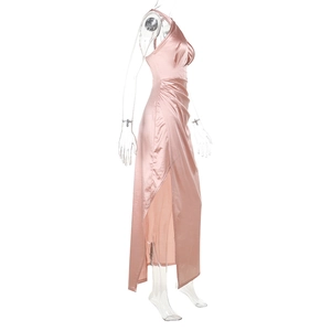 Detail of pink satin maxi dress showing the high side slit and silky draped fabric texture