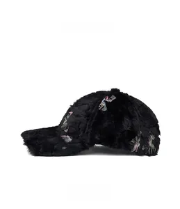 Detail of thick black plush baseball cap with colorful floral embroidery on the side