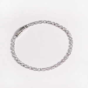 Close-up of silver-tone zircon bracelet featuring oval-cut stones and fold-over clasp