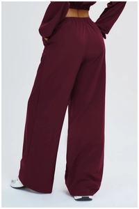 Back view of high-waisted burgundy wide-leg sun protection sports pants in flowy fabric