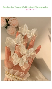 Detail of white mesh butterfly hair clips with pearls and double-layer lace design