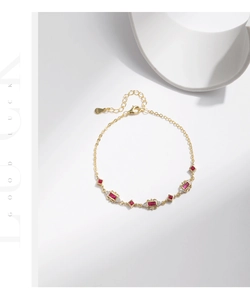 Close-up of S925 sterling silver gold bracelet with red ruby and sparkling diamonds