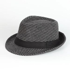 Close-up of houndstooth wool fabric texture and black ribbon band on a retro trilby hat