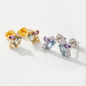 Detailed macro view of S925 sterling silver studs with colorful zircon stones in marquise cut