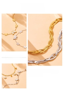 Detail of gold-plated chain bracelet with butterfly and heart charms for women