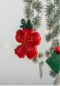 Close-up of red felt flower Christmas ornament with gold embroidery and green bow