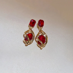 Vintage gold drop earrings with multifaceted red crystals in a geometric design