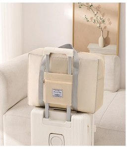 Travel bag back sleeve detail showing how it fits securely over a suitcase handle