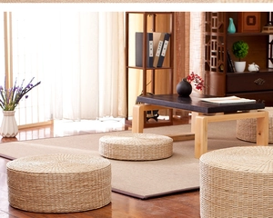 Detail showing various heights of natural woven straw tatami floor cushions in a zen tea room